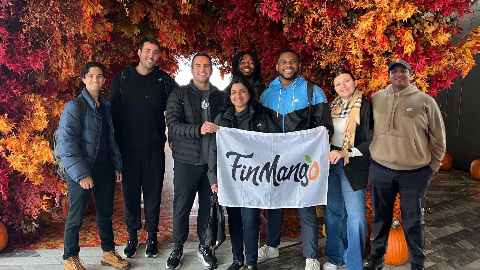 The FinMango team holding the FinMango flag